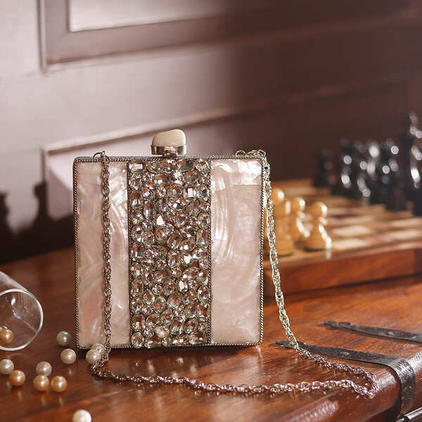Liyana Mother of Pearl Clutch by The Tan Clan featuring iridescent mother of pearl surface and elegant compact design.