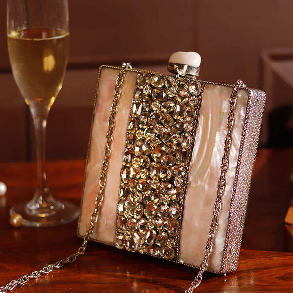 Liyana Mother of Pearl Clutch by The Tan Clan featuring iridescent shell with sleek design and compact size for elegant occasions.