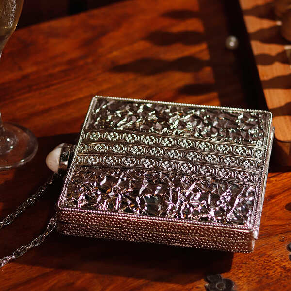 Liyana Mother of Pearl Clutch by The Tan Clan featuring iridescent pearl accents and a sleek elegant design for evening wear.