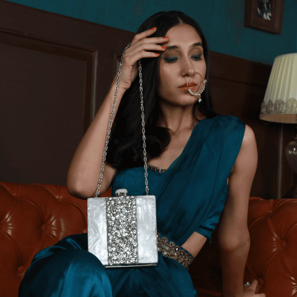 Liyana Mother of Pearl Clutch by The Tan Clan featuring a glossy, iridescent pearl finish and elegant rectangular shape.