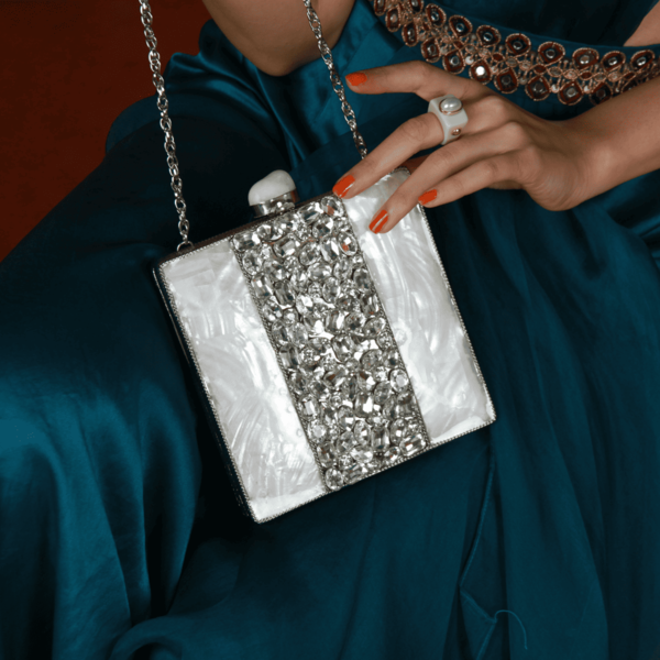 Liyana mother of pearl clutch by The Tan Clan featuring a shimmering pearl surface and elegant rectangular design.