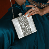 Liyana mother of pearl clutch by The Tan Clan featuring a shimmering pearl surface and elegant rectangular design.