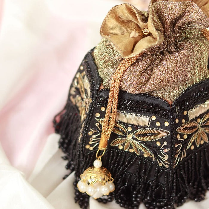 Hand embroidered Magha Half Lotus Potli bag by The Tan Clan with intricate embroidery and traditional design.