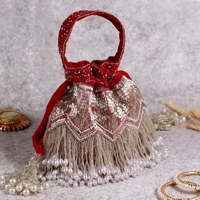 Meher Potli with handle by The Tan Clan, stylish traditional Indian purse featuring intricate embroidery and a convenient handle.