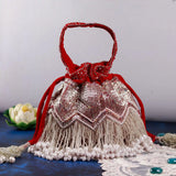 Meher Potli with handle from The Tan Clan, traditional fabric bag with decorative design and a sturdy handle for carrying.