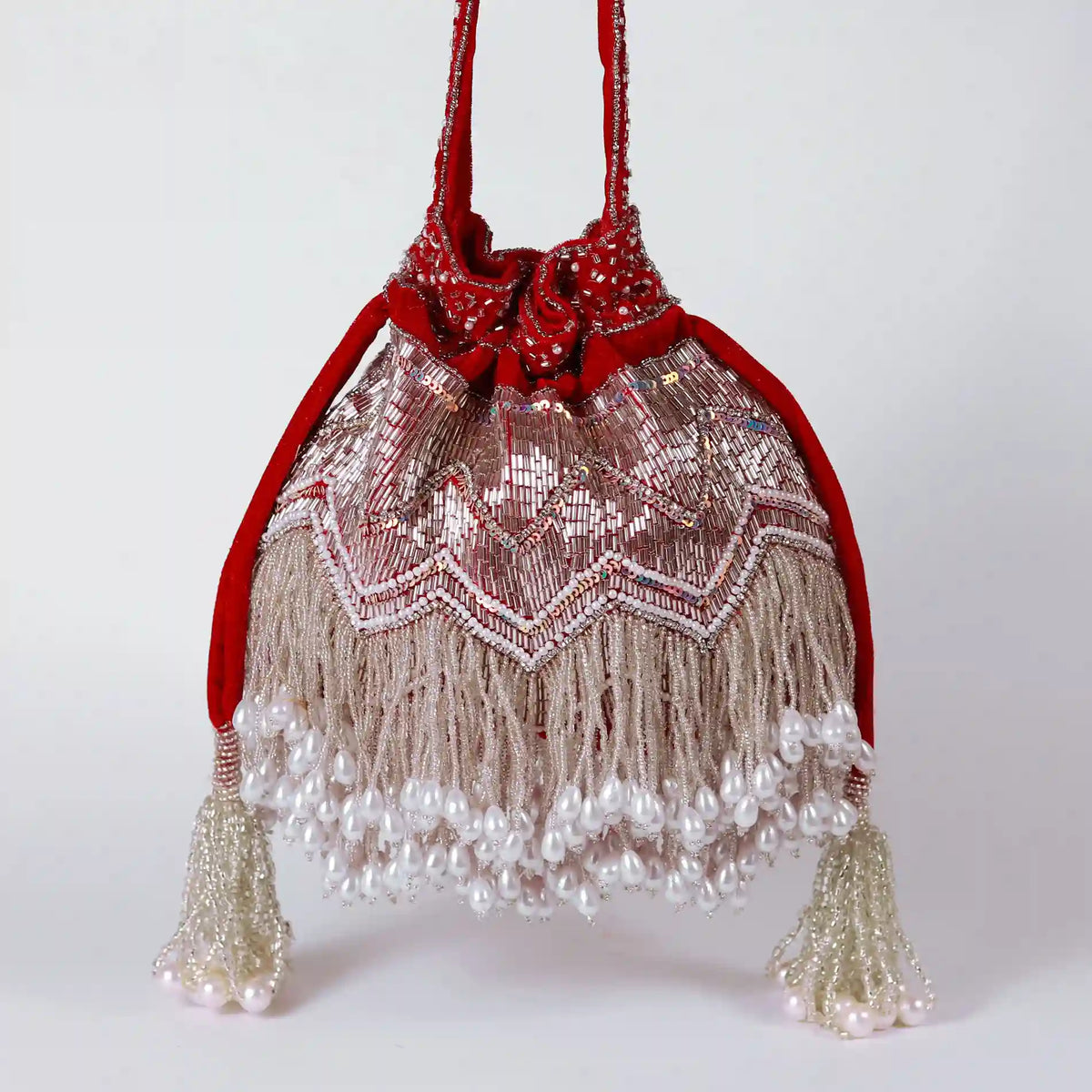 Meher Potli bag with handle by The Tan Clan, featuring intricate embroidery and traditional design for ethnic wear.