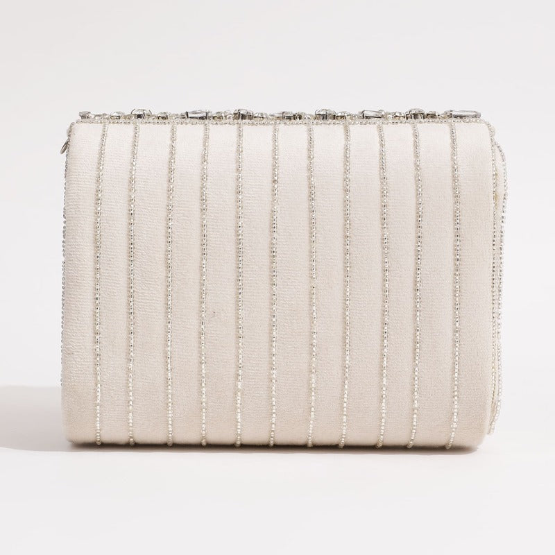 Mehfil Combo from THE TAN CLAN featuring a Noor Mother of Pearl clutch and a Grace white flap bag, both with elegant designs.