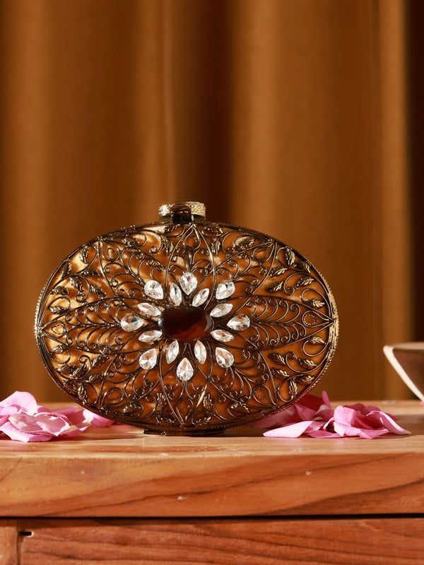 Intricate embellished brass clutch by The Tan Clan featuring detailed craftsmanship and elegant design.