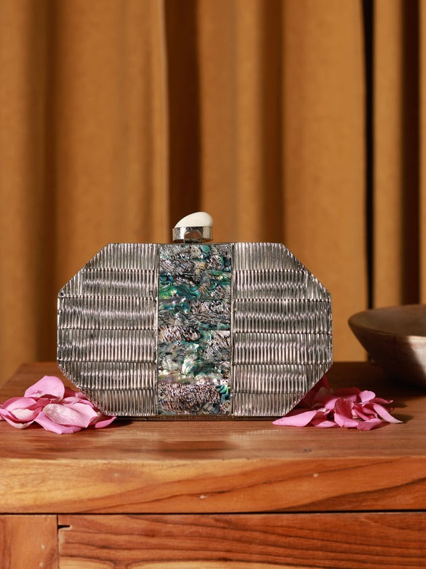 Silver Mother of Pearl clutch bag by The Tan Clan featuring a sleek, elegant design with a metallic finish and compact size.