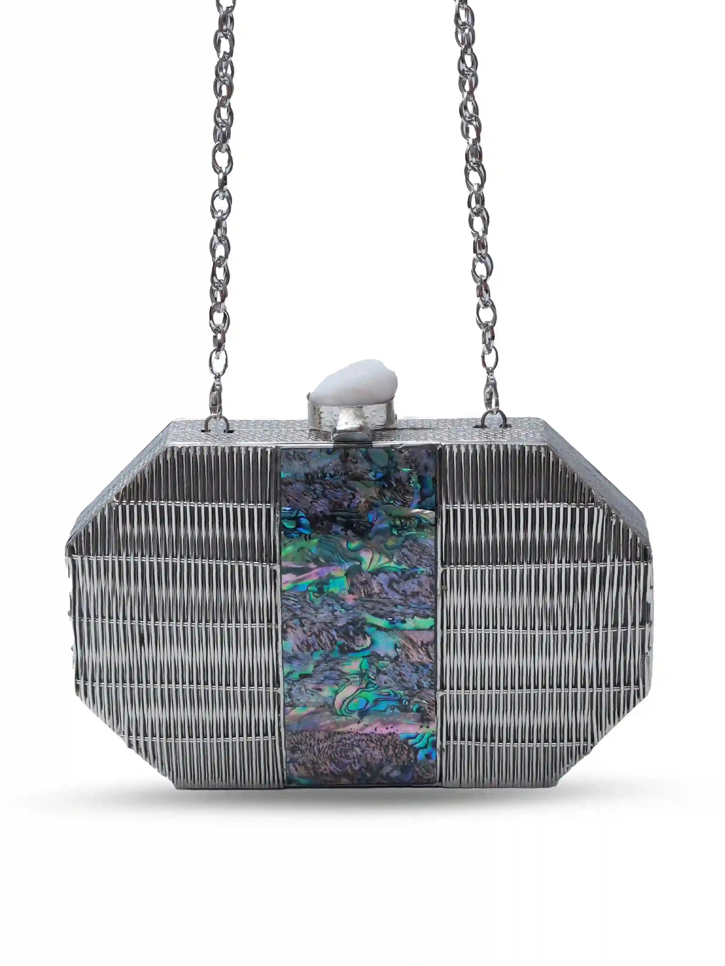 Misha Silver Mother of Pearl clutch by The Tan Clan, featuring a shimmering silver exterior with elegant mother of pearl detailing.