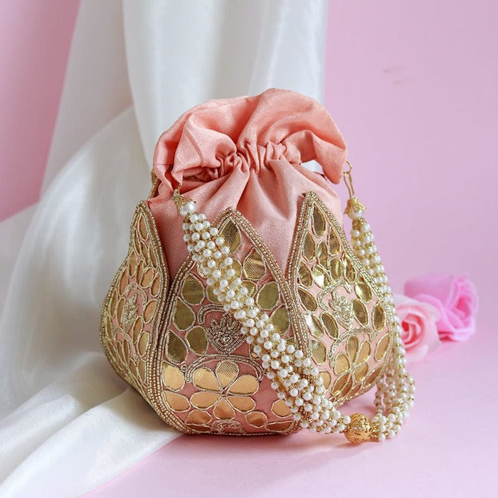 Mini lotus-shaped potli bag with intricate gota patti handwork by The Tan Clan, featuring traditional embroidery and a decorative drawstring.