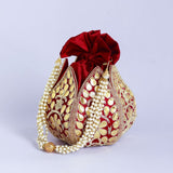 Mini lotus-shaped potli bag with intricate Gota Patti handwork by The Tan Clan, featuring traditional embroidery and a drawstring closure.