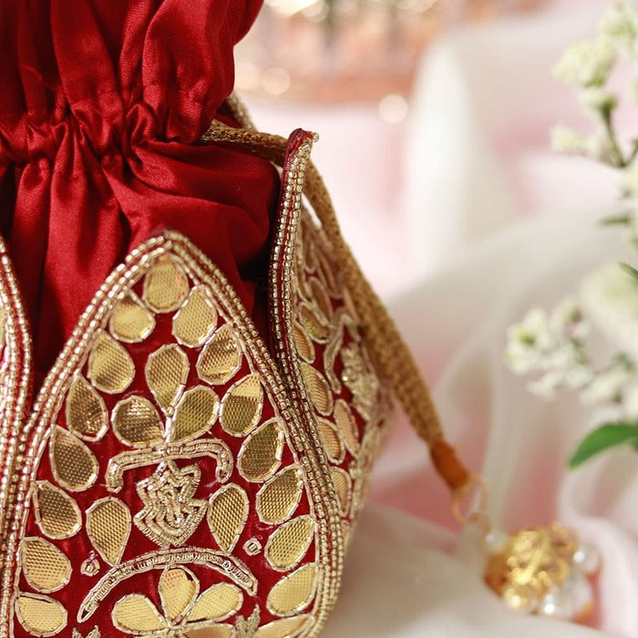 Mini lotus-shaped potli bag with intricate Gota Patti handwork by The Tan Clan, featuring delicate embroidery and traditional design.