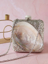 Elegant Mumtaz Mother of Pearl Clutch by The Tan Clan featuring iridescent pearl details and a sleek, compact design.