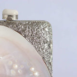 Mother of pearl clutch bag by The Tan Clan with elegant, iridescent surface and sleek design, perfect for evening occasions.