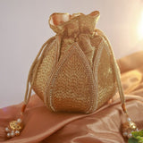 Mini lotus potli bag with hand embroidery by The Tan Clan, featuring intricate floral designs suitable for traditional occasions.