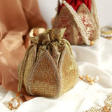 Hand-embroidered mini lotus potli bag by The Tan Clan, featuring intricate embroidery and traditional design for elegant occasions.
