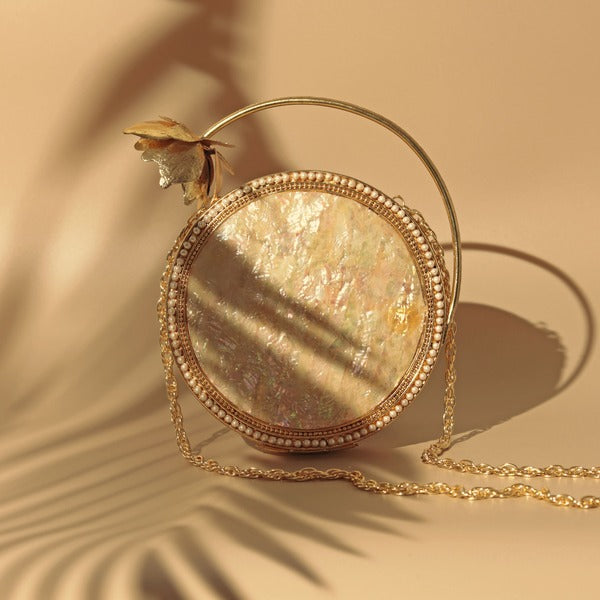 Naaz embellished mother of pearl clutch bag by The Tan Clan, featuring intricate detailing and elegant design.
