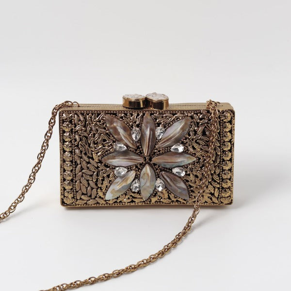 Nadia embellished mother of pearl clutch by The Tan Clan featuring a shimmering pearl surface and elegant design.