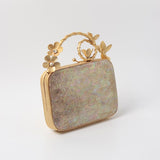 Naira Mother of Pearl Clutch by The Tan Clan featuring brass-embellished handle and elegant mother of pearl exterior.