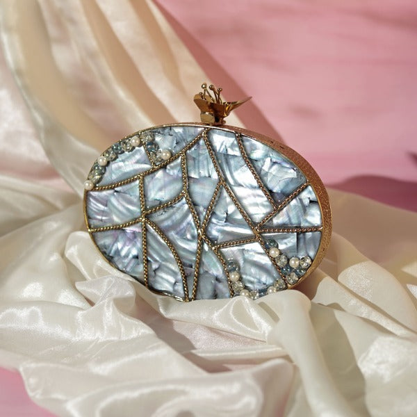 Nargis embellished mother of pearl clutch by The Tan Clan featuring intricate detailing and a sleek, elegant design.
