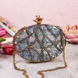 Elegant Nargis embellished mother of pearl clutch by The Tan Clan with intricate detailing and a sleek, sophisticated design.