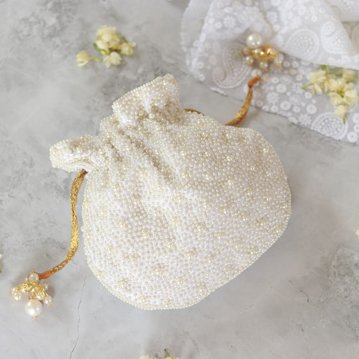 Nayaab Pearl Potli Bag with Handle by The Tan Clan, featuring intricate pearl embroidery and traditional design.