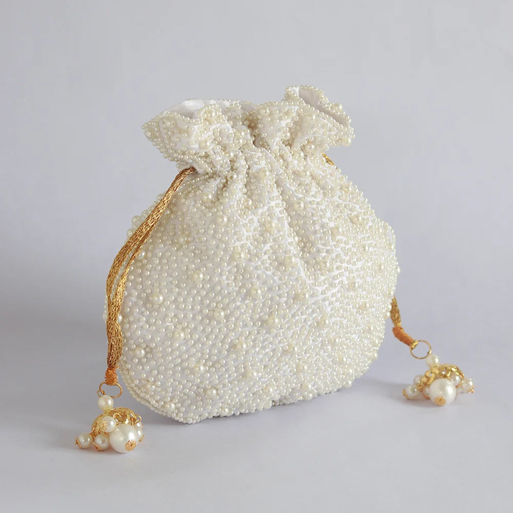 Nayaab Pearl Potli Bag with Handle by The Tan Clan featuring intricate pearl embroidery and traditional Indian design.