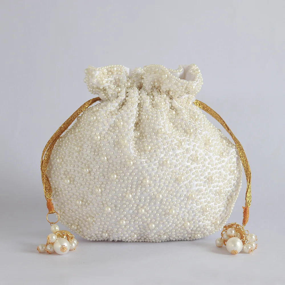 Nayaab pearl potli bag with handle by The Tan Clan, featuring intricate pearl embroidery and traditional ethnic design.