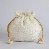 Nayaab pearl potli bag with handle by The Tan Clan, featuring intricate pearl embroidery and traditional ethnic design.