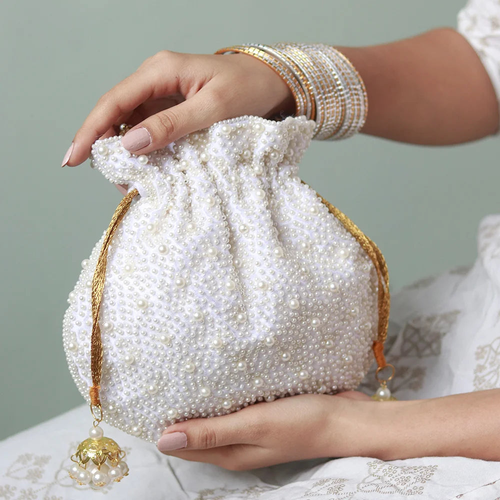 Nayaab pearl potli bag with handle and intricate embroidery, stylish traditional accessory by The Tan Clan.
