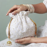 Nayaab pearl potli bag with handle and intricate embroidery, stylish traditional accessory by The Tan Clan.