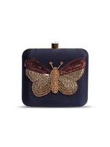 Nigah black square clutch by The Tan Clan with hand-embroidered butterfly design on fabric.