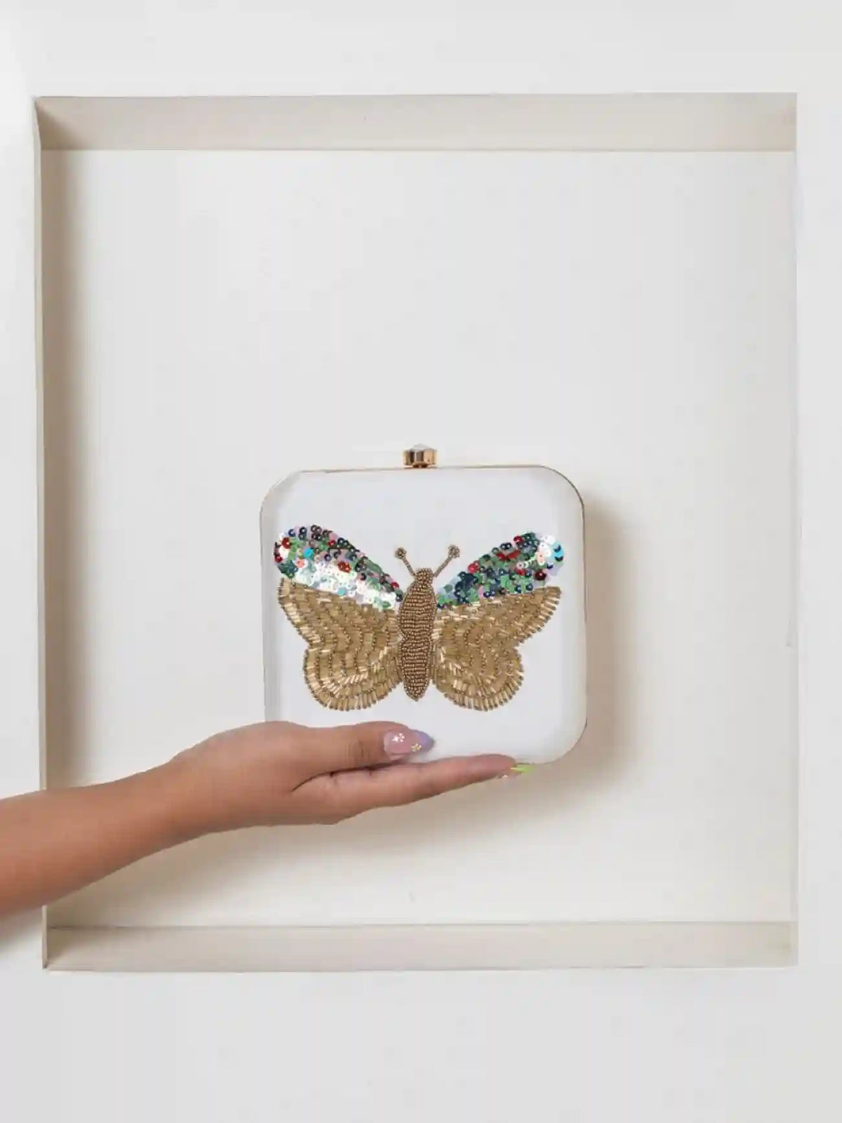 White square clutch bag with hand-embroidered butterfly design by The Tan Clan, stylish accessory for special occasions.