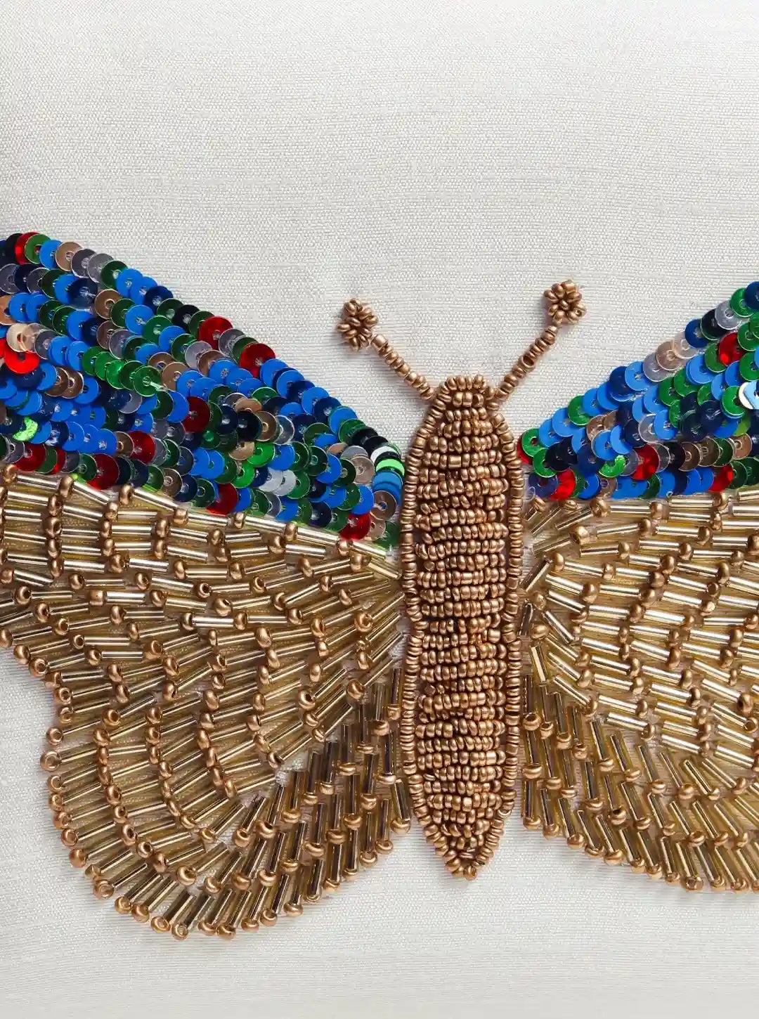 White square clutch by The Tan Clan with hand-embroidered butterfly design, featuring intricate detailing and elegant craftsmanship.