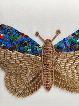 White square clutch by The Tan Clan with hand-embroidered butterfly design, featuring intricate detailing and elegant craftsmanship.