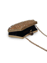 Intricate brass clutch bag with detailed embellishments from The Tan Clan, showcasing its elegant design and craftsmanship.