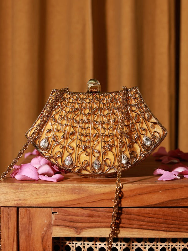 Elegant brass clutch by The Tan Clan with intricate embellishments and detailed craftsmanship, showcasing a stylish evening accessory.