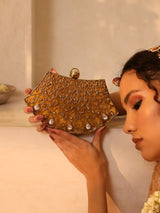 Intricate embellished brass clutch by The Tan Clan with detailed craftsmanship and elegant design for special occasions