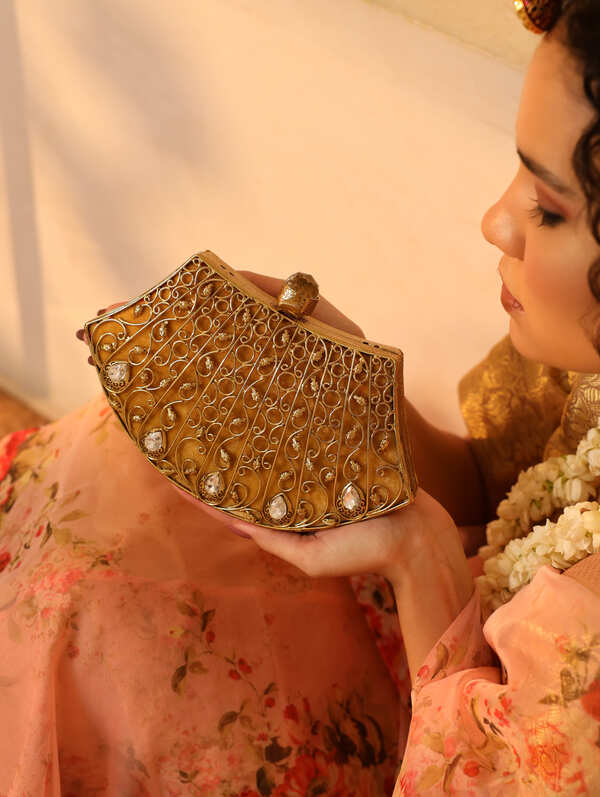 Nitya embellished brass clutch by The Tan Clan featuring intricate detailing and traditional design for elegant occasions.