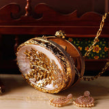 Noor golden brass clutch with mother of pearl detailing by The Tan Clan, featuring a sleek, elegant design.