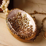 Noor Golden Brass Mother of Pearl Clutch by The Tan Clan featuring intricate brass and pearl design with a sleek clasp closure.