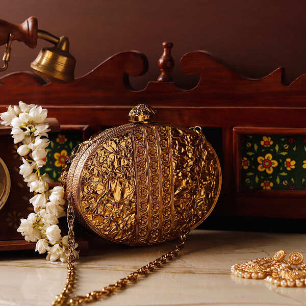 Noor golden brass clutch with mother of pearl accents from The Tan Clan, featuring a sleek and elegant design.