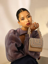 Nysa beige mini bag by The Tan Clan featuring an embroidered handle and compact, stylish design.