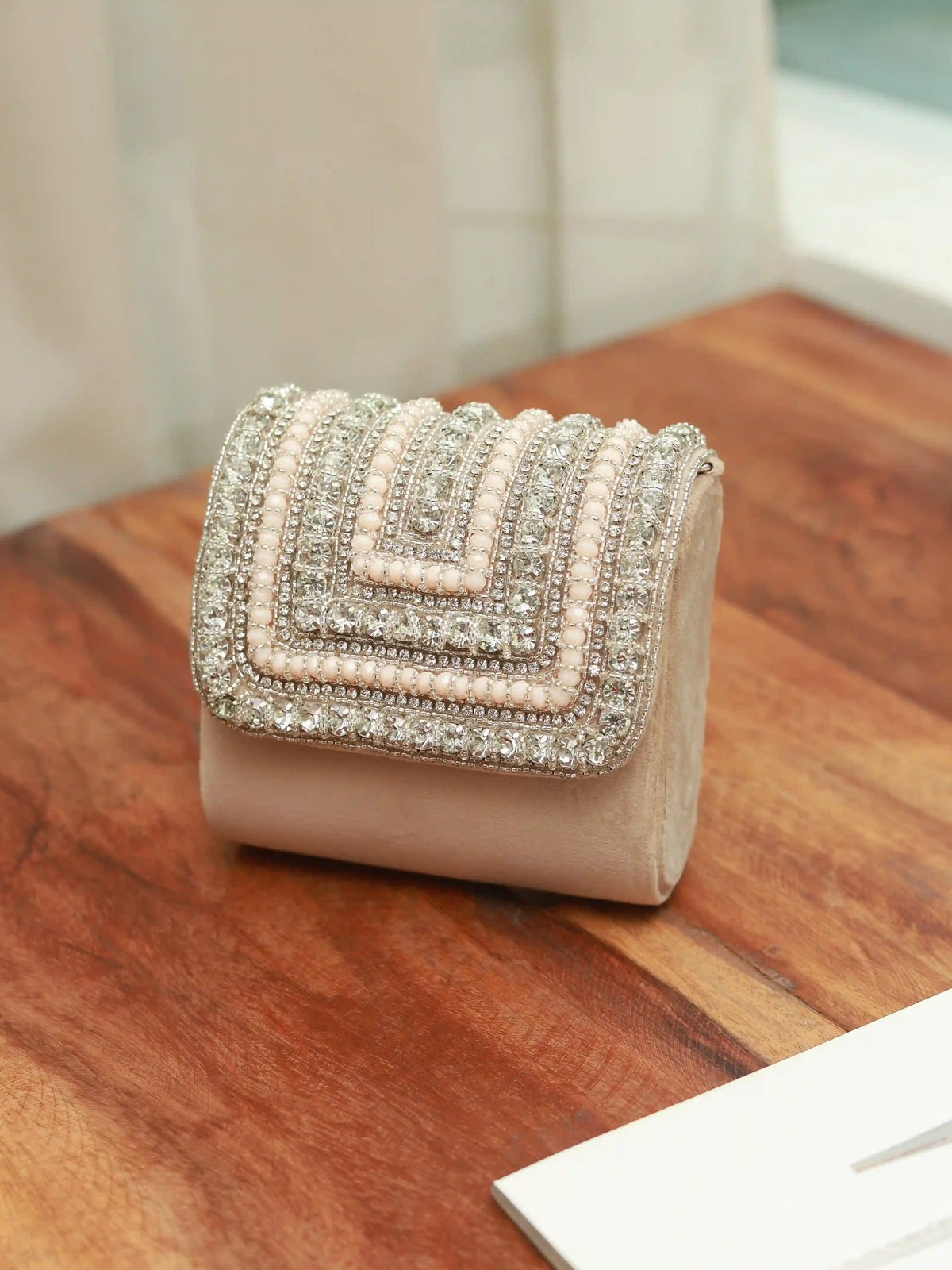 Nysa beige mini bag by The Tan Clan with embroidered handle, showcasing compact design and stylish details.