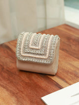 Nysa beige mini bag by The Tan Clan with embroidered handle, showcasing compact design and stylish details.