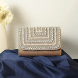 Nysa embellished flap-over clutch bag by The Tan Clan with decorative details and a sleek, compact design for evening use.