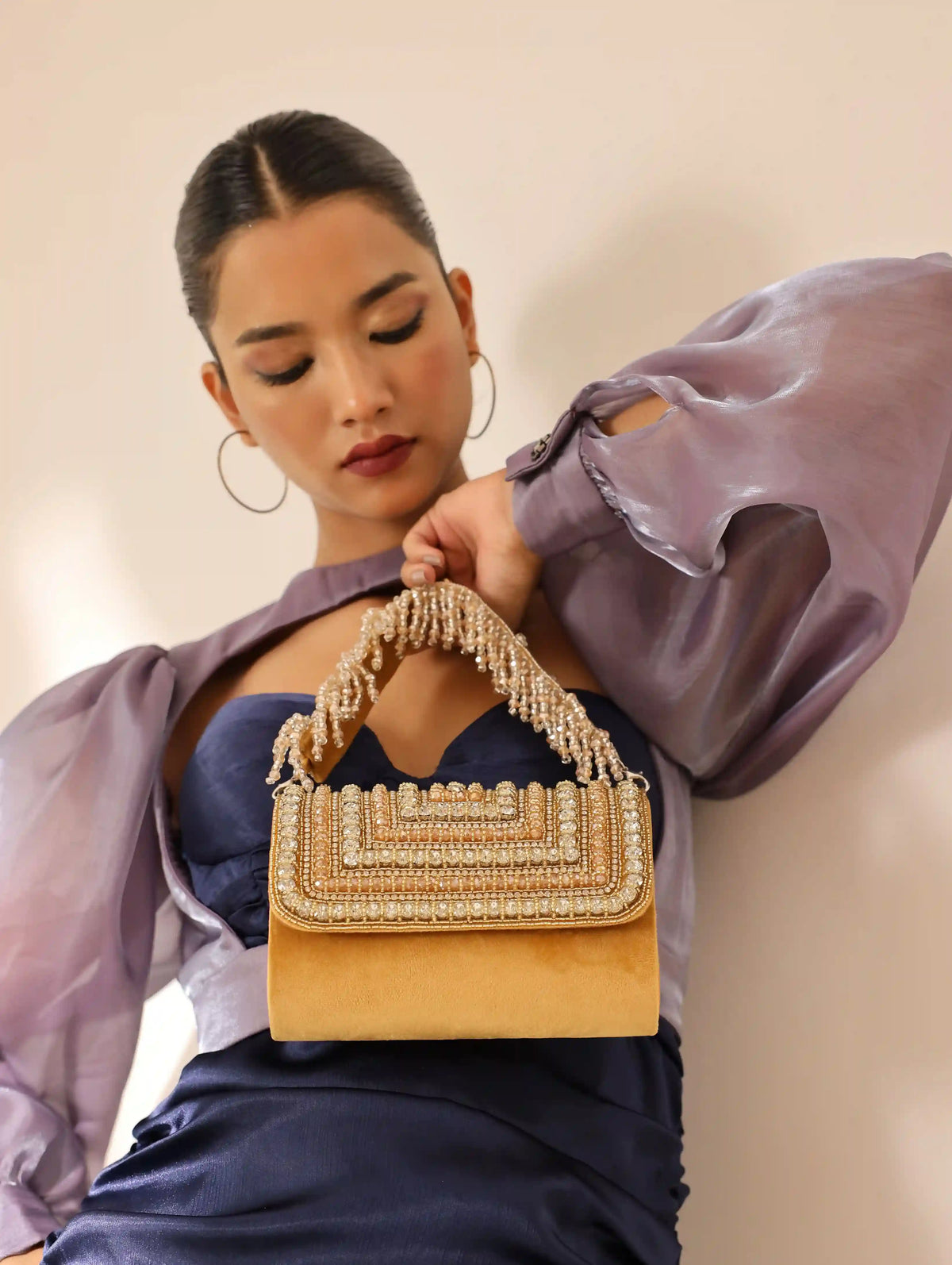 Gold embellished flap-over clutch bag by The Tan Clan, stylish accessory with elegant detailing and compact design.