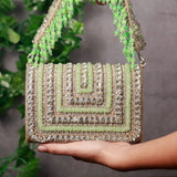 Nysa green embellished flap-over clutch bag by The Tan Clan, featuring intricate embellishments and a sleek design for elegant occasions.