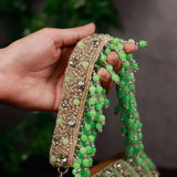 Green Nysa clutch bag with embellished flap over design by The Tan Clan, featuring a stylish and elegant accessory for evening occasions.